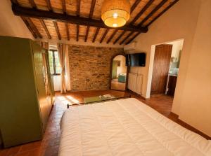 a bedroom with a large bed in a room at Tenuta di Valmarino - Adults only in Corciano