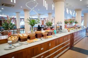 a buffet line with food on it in a restaurant at Palace Hotel Vung Tau in Vung Tau