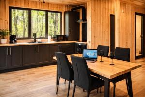 a kitchen with a wooden table with a laptop on it at Secret Sanctuary in Brad