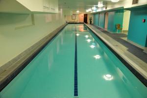 a large swimming pool in a building at Adina Heritage Christchurch in Christchurch