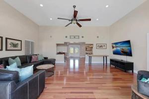 a living room with a couch and a ceiling fan at Home with pool by Dream Vacation in Fort Lauderdale