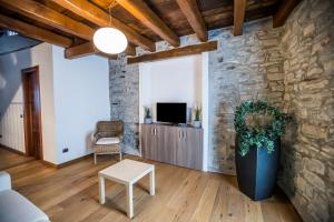 a living room with a stone wall at Borgo Molina in Faggeto Lario 