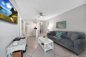 a living room with a couch and a table at Beach Apart by Dream Vacation unit 3 in West Palm Beach