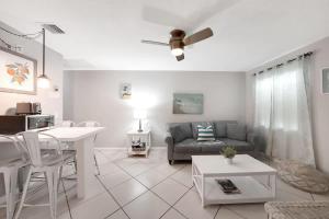 a living room with a couch and a table at Beach Apart by Dream Vacation unit 3 in West Palm Beach