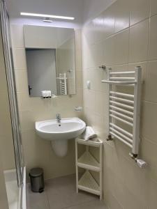 a bathroom with a sink and a mirror at Hotel Miramar in Sopot