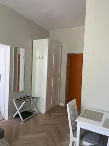 a room with a table and a white refrigerator at Hotel Miramar in Sopot