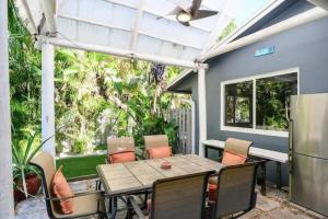 a patio with a wooden table and chairs at Peacock Villa 2 by Dream Vacation in Fort Lauderdale
