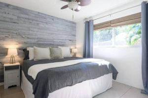 a bedroom with a bed and a wooden wall at Peacock Villa 2 by Dream Vacation in Fort Lauderdale