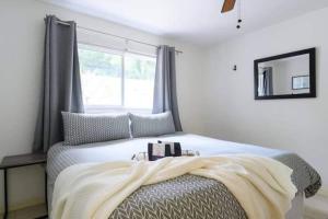 a bedroom with a bed with a blanket on it at The peacock villa 1 by Dream Vacation in Fort Lauderdale