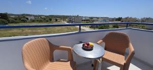 a bowl of fruit on a table on a balcony at Marika Apartments in Mastihari +13 photos