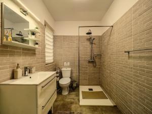a bathroom with a sink and a toilet and a shower at Ben Apartments Near City Center in Sibiu