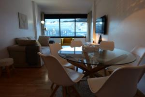 a living room with a glass table and chairs at Soldeu Paradis Clos in Soldeu