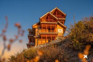 a wooden house on the side of a hill at Zostel Homes Gadagushaini, Jibhi in Jibhi