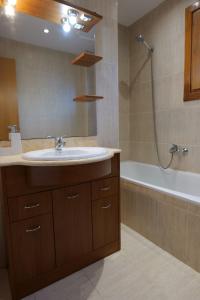 a bathroom with a sink and a bath tub at Soldeu Paradis Clos in Soldeu