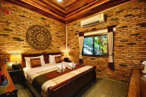 Ліжко або ліжка в номері Hotel Khaosok and Spa