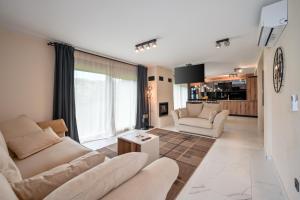 a living room with two couches and a table at 4 bedroom home Sigma in Zlatar