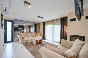 a living room with couches and a fireplace at 4 bedroom home Sigma in Zlatar