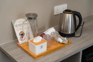 a counter with a coffee maker and a blender at Wangs Hotel Gurney Drive in George Town