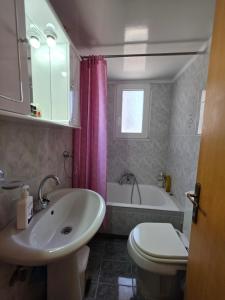 a bathroom with a sink and a tub and a toilet at Sidirounda Traditional House 1 in Sidiroúnta +21 photos