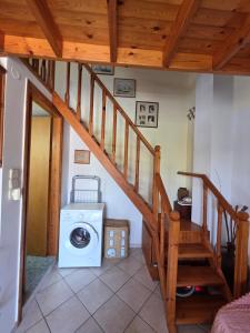 a room with a washing machine and a staircase at Sidirounda Traditional House 1 in Sidiroúnta