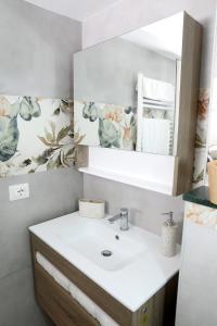 a bathroom with a sink and a mirror at La Rosa di Antonio & Relax Room in Tricase +29 photos