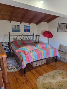 a bedroom with a bed with a colorful comforter at Sidirounda Traditional House 1 in Sidiroúnta