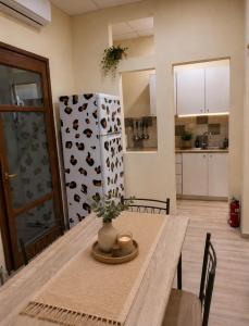 a kitchen and dining room with a table and a refrigerator at Casa Polyxeni -Elegant Stay in Vathi in Samos