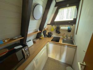 a small kitchen with a sink and a window at Bodenseehäusle in Immenstaad am Bodensee