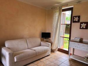 a living room with a couch and a window at La Madonnina Agriturismo Dorè in Alba +33 photos