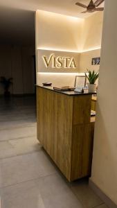 a vista desk in an office with a sign on the wall at Hotel Vista by Booksy One Kollam Near Kollam Bypass in Kollam +16 photos