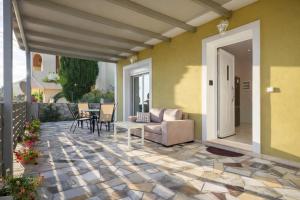 a patio with a couch and a table and chairs at villa Silda in Atsoupádhes