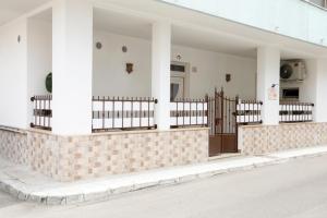 a building with a gate on the side of a street at La Rosa di Antonio & Relax Room in Tricase