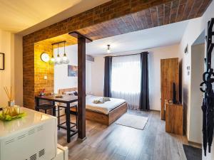 a bedroom with a bed and a table in a room at Ben Apartments Near City Center in Sibiu