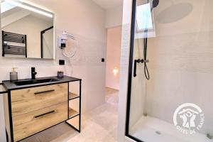 a bathroom with a sink and a shower with a mirror at Rozen in Roz-Landrieux +35 photos