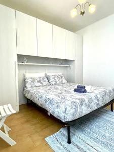 a bedroom with a bed with white cabinets and a rug at Perfect Wave a 10 m dal mare in Sanremo
