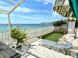 a patio with chairs and a view of the ocean at Perfect Wave a 10 m dal mare in Sanremo