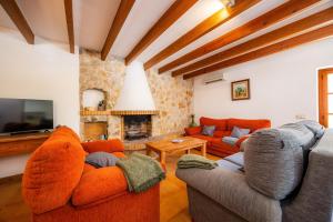 a living room with two couches and a fireplace at Villa Cal Apostol in Pollença