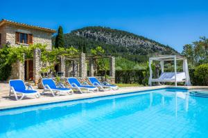 a pool with chairs and a gazebo at Villa Cal Apostol in Pollença