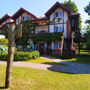 a house with a staircase in front of it at Złota Rybka in Rowy