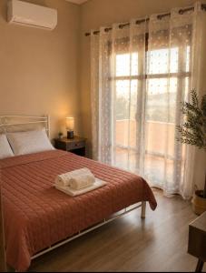 a bedroom with a bed with two towels on it at Casa Polyxeni -Elegant Stay in Vathi in Samos