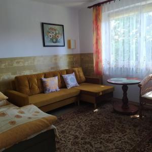 a living room with a couch and a window at Złota Rybka in Rowy