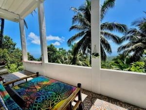 a balcony with a bench and a view of the ocean at el balcon camiguin in Mambajao