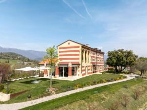 a large building with red and white stripes at Tenuta Duchi Corbanus in Corbanese