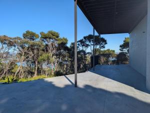 a view from the outside of a building with a pole at Gumlands Retreat in Auckland