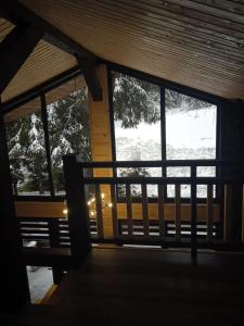 a view of a porch with a view of a snow covered yard at Котедж Арпад in Synevyr
