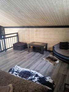 a room with two beds and a table in a cabin at Котедж Арпад in Synevyr