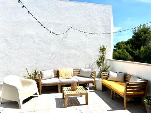 a patio with couches and a table and chairs at Casa Calafat in Calafat
