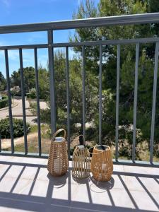 a group of three baskets sitting on a balcony at Casa Calafat in Calafat