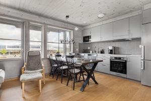 a kitchen with a dining room table and chairs at Funäsdalshöjden - Funäsdalen in Funäsdalen