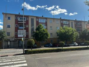 a large building with cars parked in a parking lot at PIO XII XXl B in Talavera de la Reina